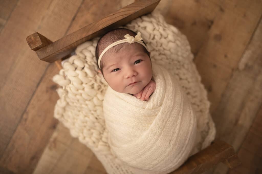 wichita photographer newborn photography baby girl on bed