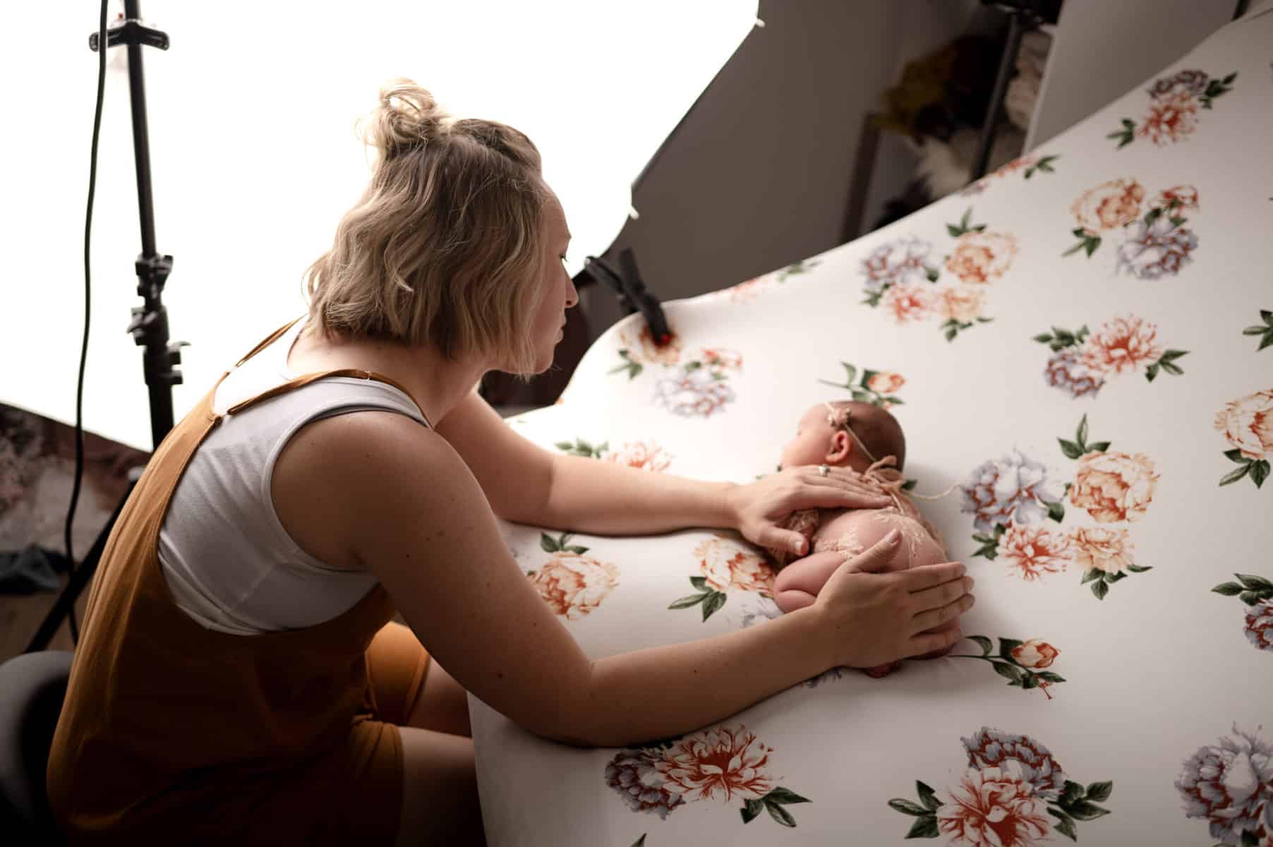 wichita newborn photographer Sara Nuzum sooths a newborn baby