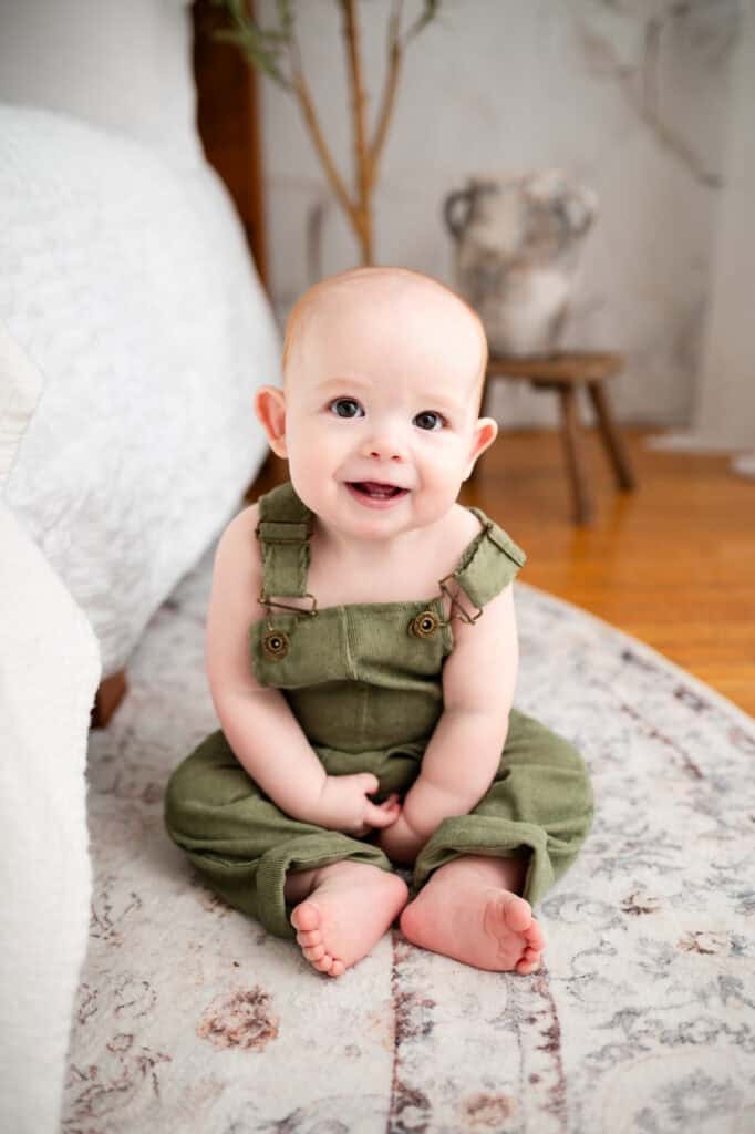 family photographer wichita ks baby sits on rug first birthday photos