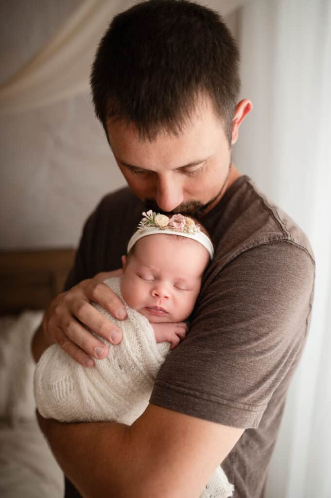 newborn photography wichita ks dad snuggles new baby girl