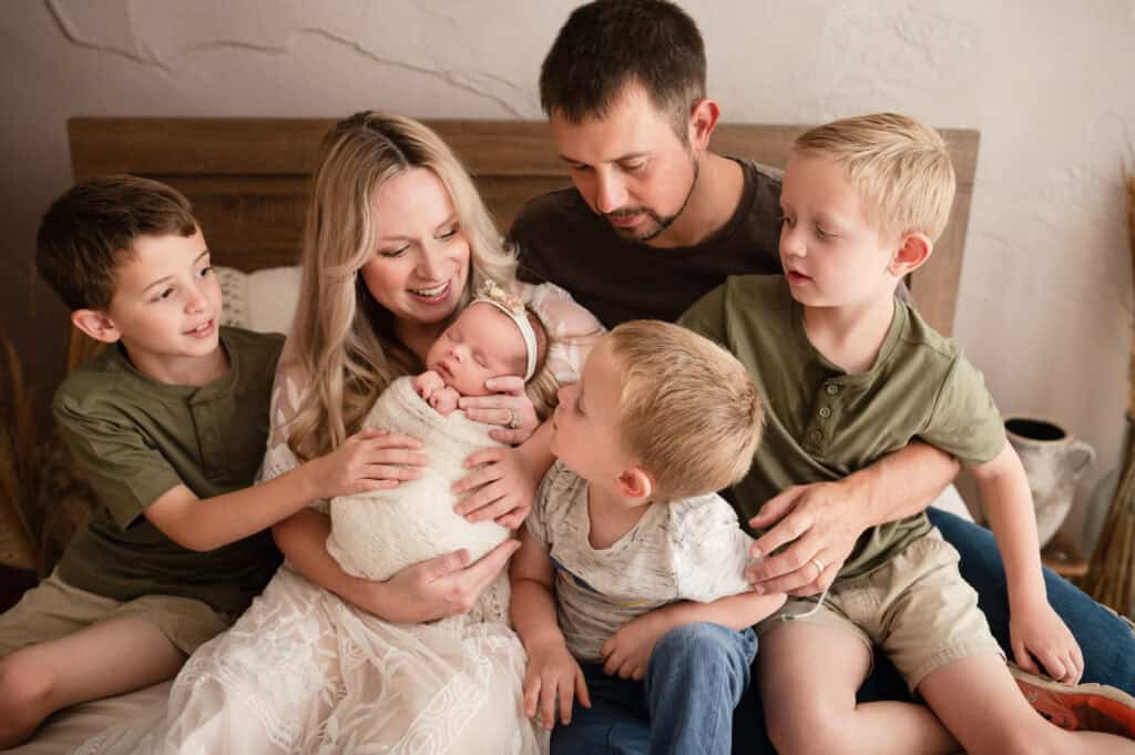 newborn photography wichita ks family of 6 smiles at new baby girl